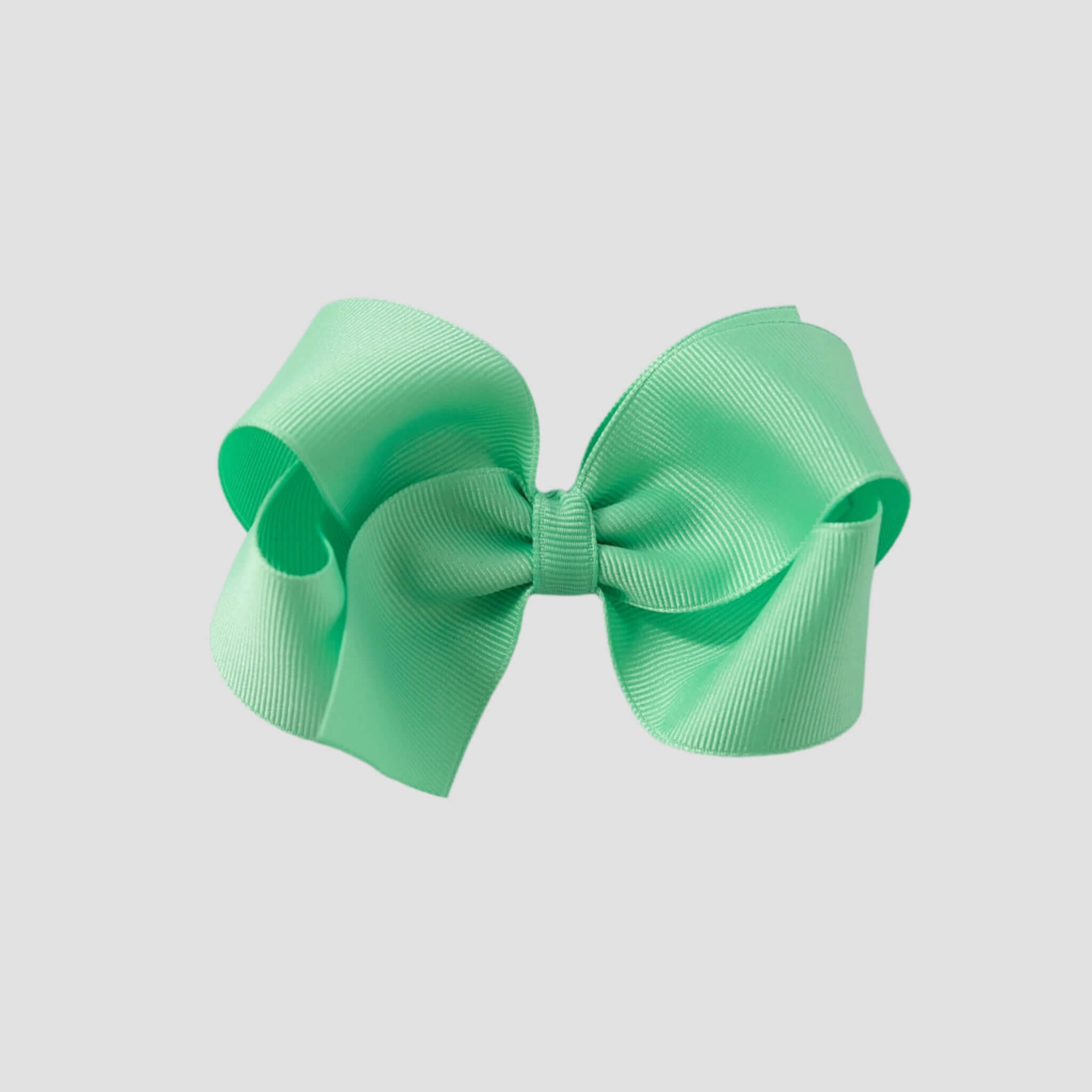 Mint green hair bow on a white background