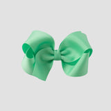 Mint green hair bow on a white background