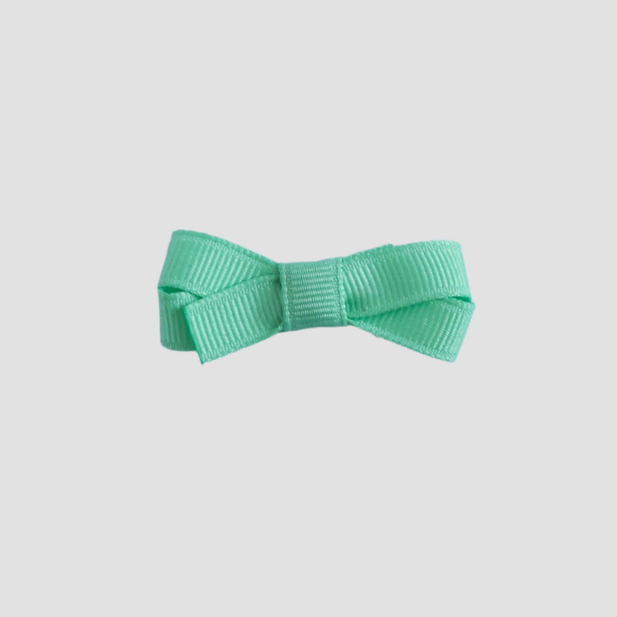 Mint green bow on a white background
