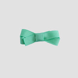 Mint green bow on a white background