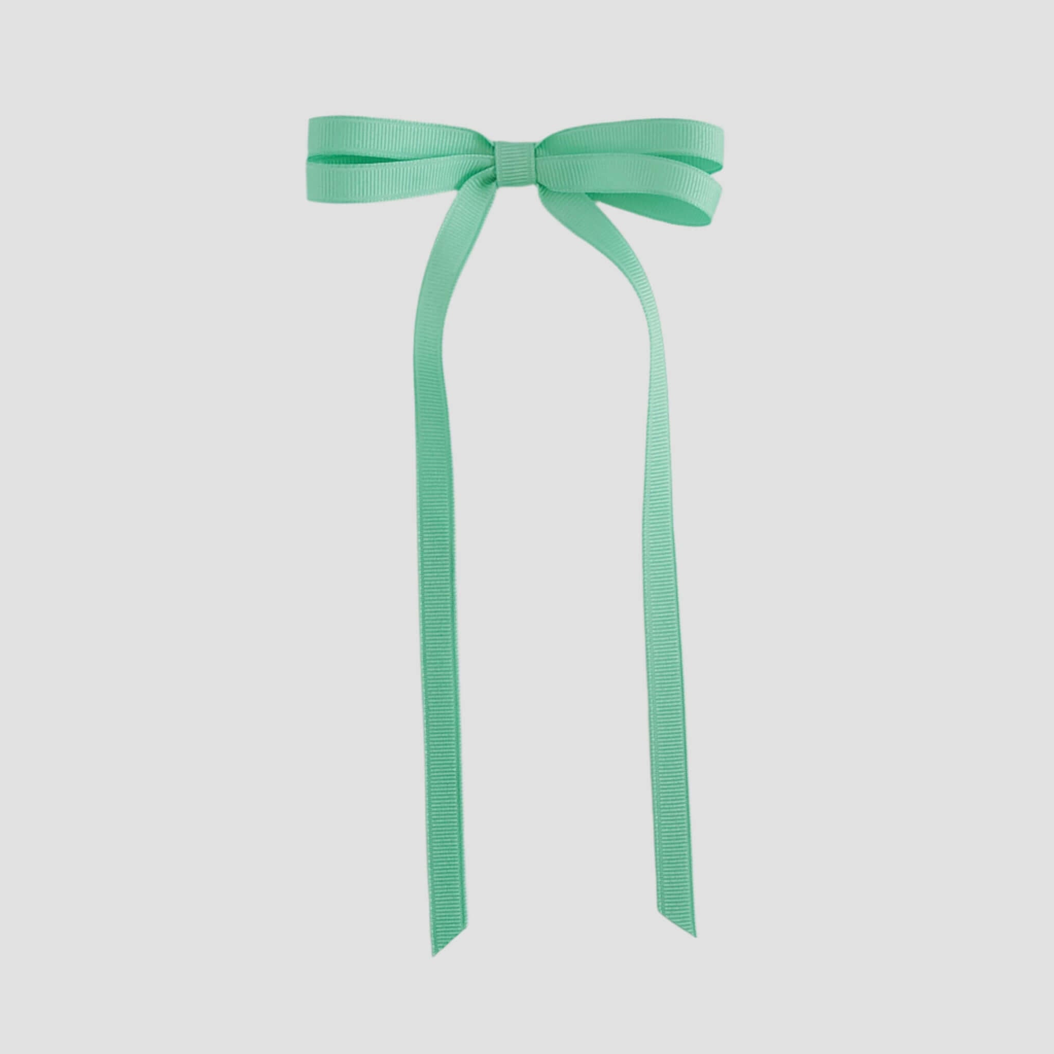 Mint green ribbon bow on a white background