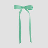 Mint green ribbon bow on a white background