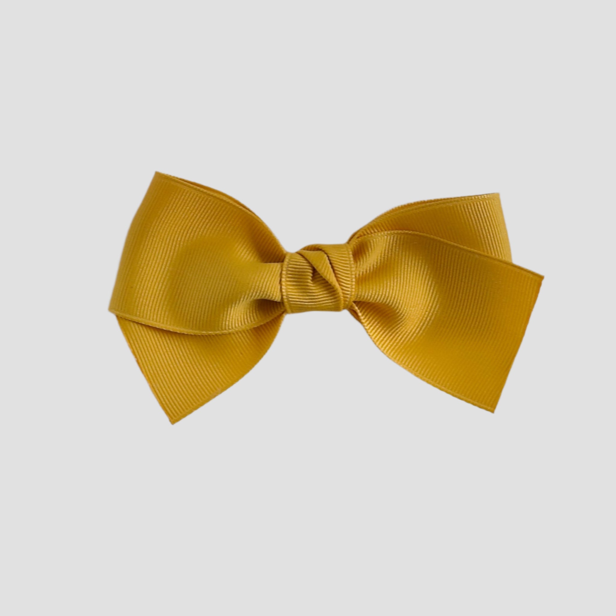 Mustard yellow bow on a white background background