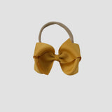 Mustard yellow bow on a nude nylon headband