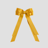 Mustard yellow bow with long tails on a white background