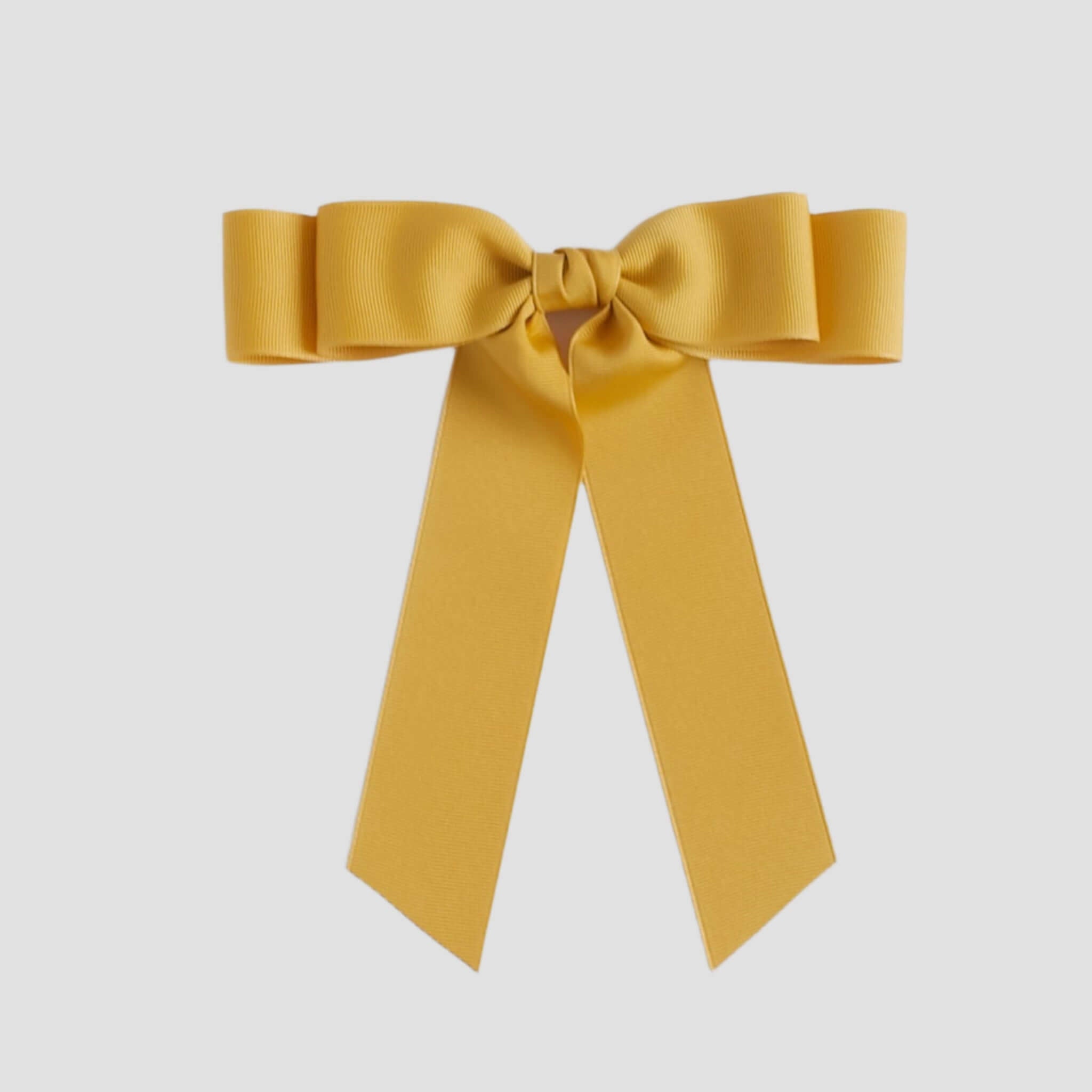 Mustard yellow bow on a white background