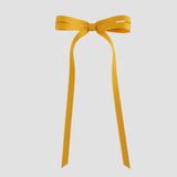Mustard yellow ribbon bow on a white background