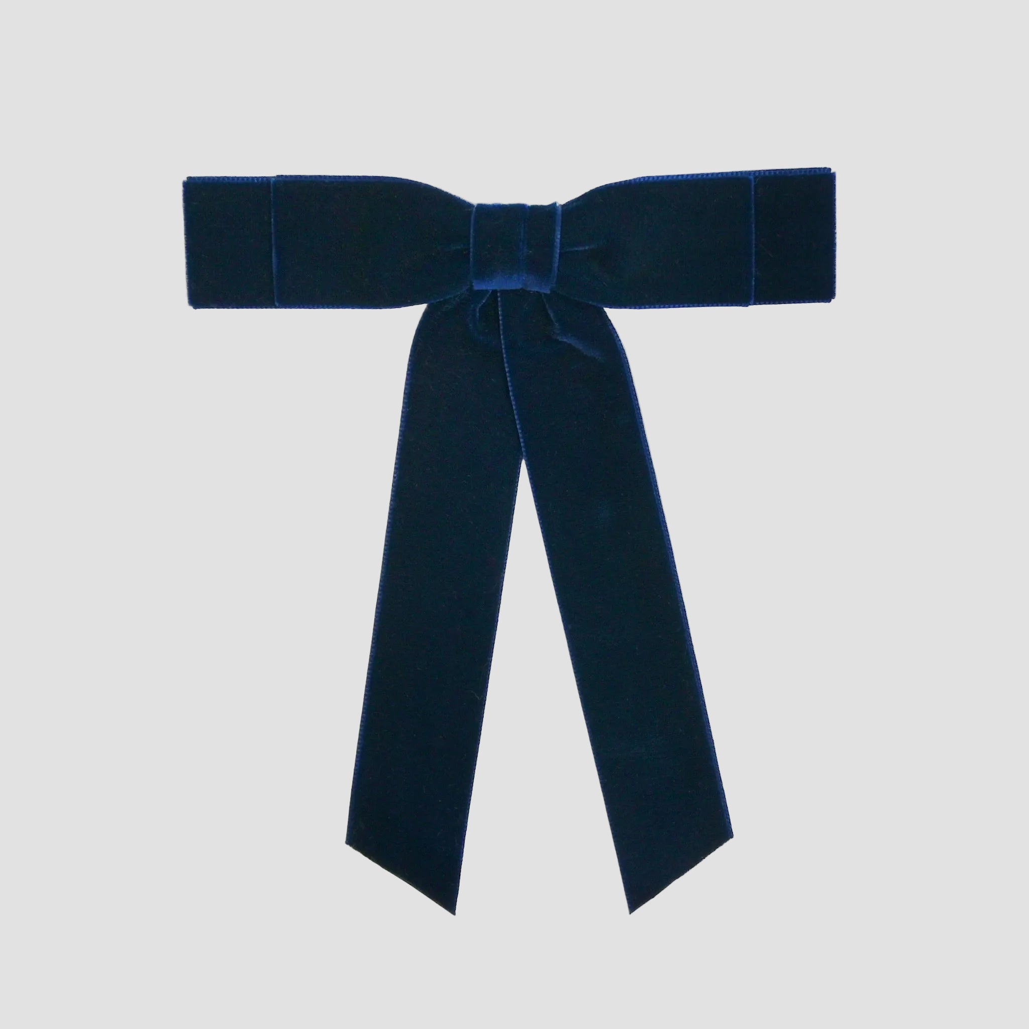 Navy blue Grace velvet hair bow for women. Double bow with long tails on white background 