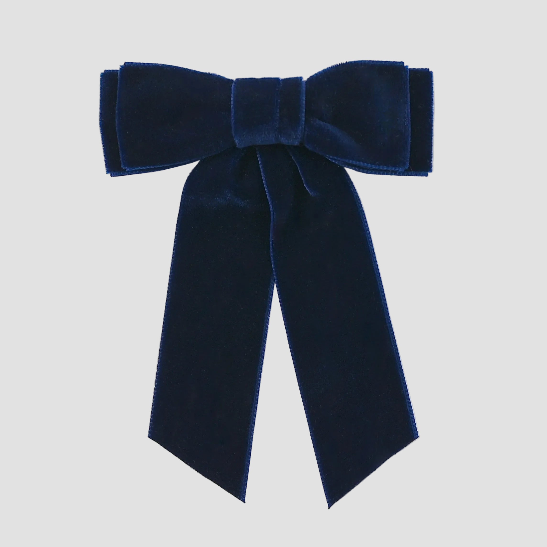 Navy blue velvet Mia bow on a white background