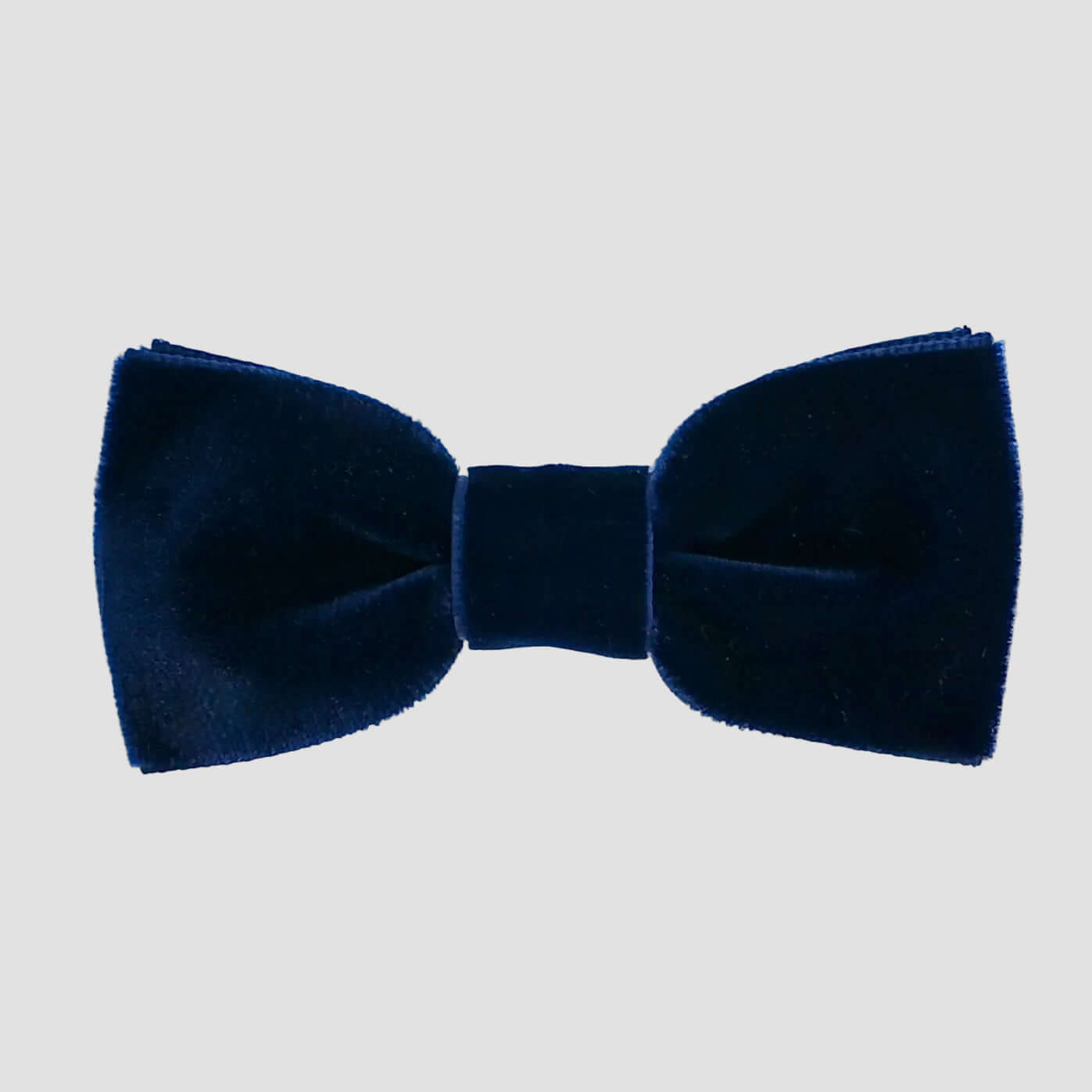 Navy blue velvet bow tie on a white background