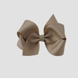 Oatmeal hair bow on a white background