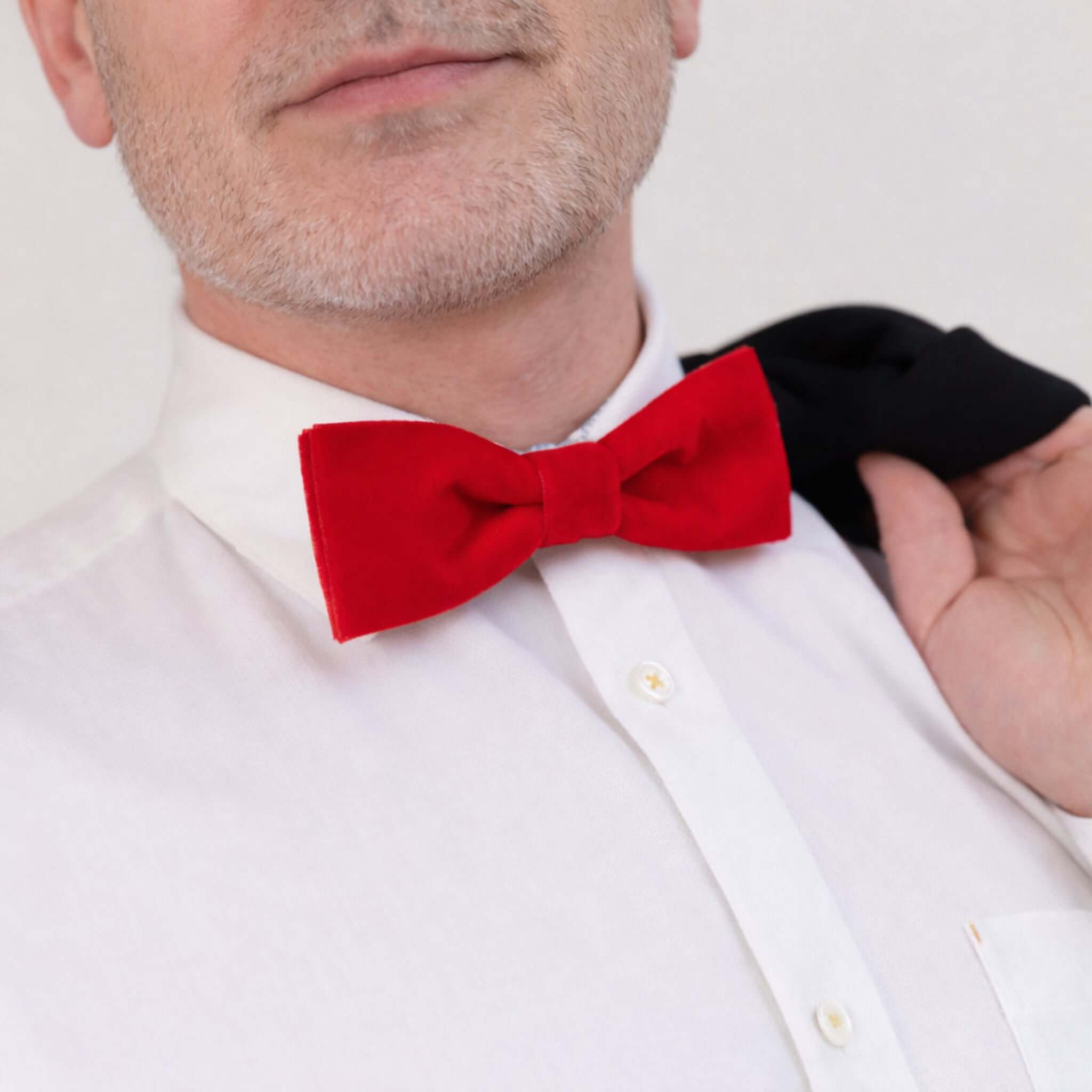 Model wearing velvet bow tie in red