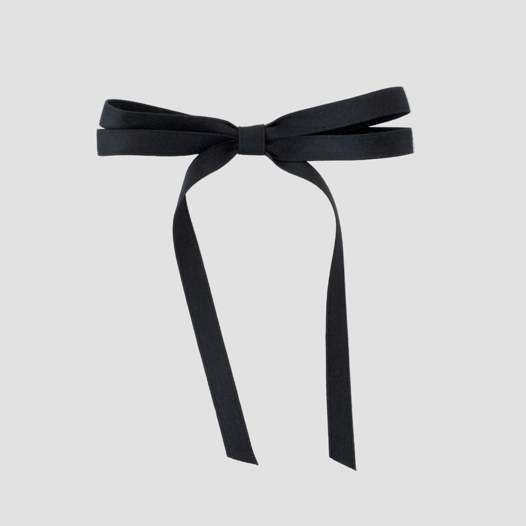 Olivia petite matte satin hair bow in black on a white background.