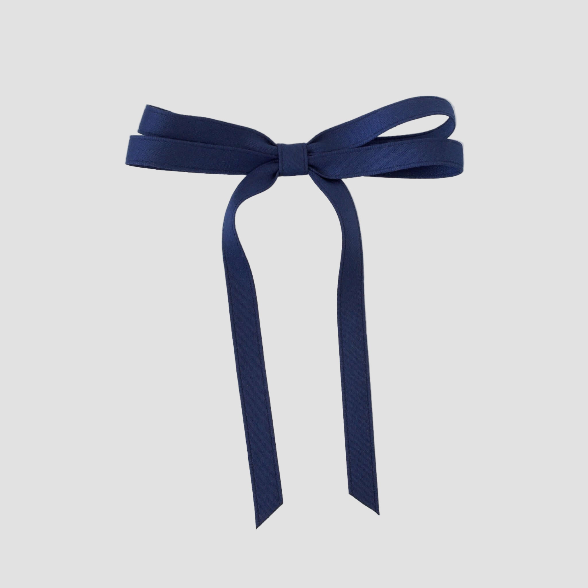 Olivia petite matte satin hair bow in light blue on a white background.