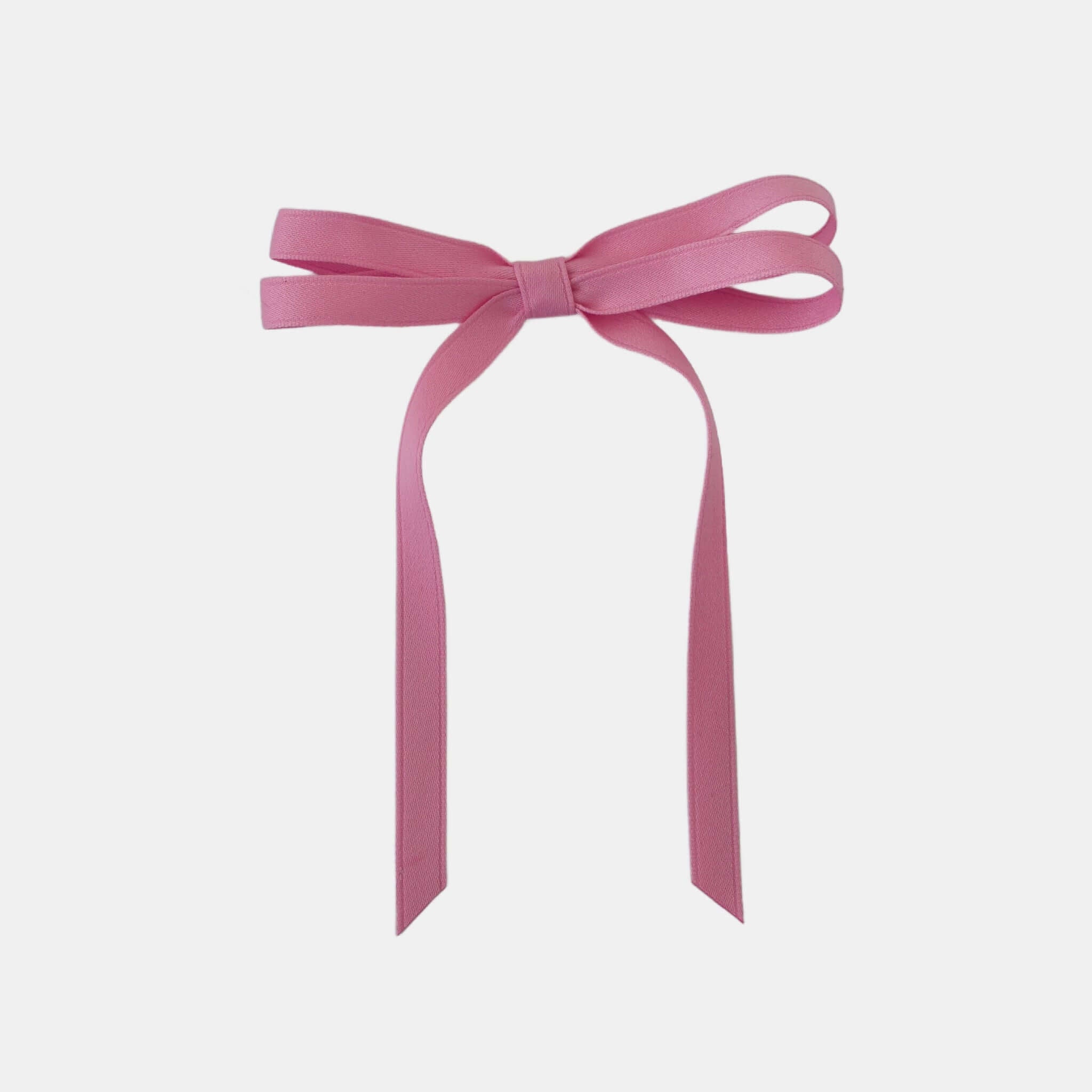 Olivia petite matte satin hair bow in pink on a white background.