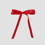 Olivia petite matte satin hair bow in red on a white background.