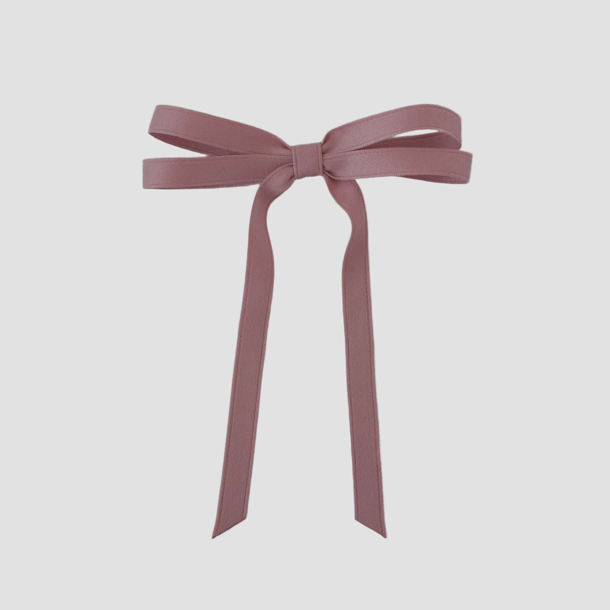 Olivia petite matte satin hair bow in dusty rose on a white background.