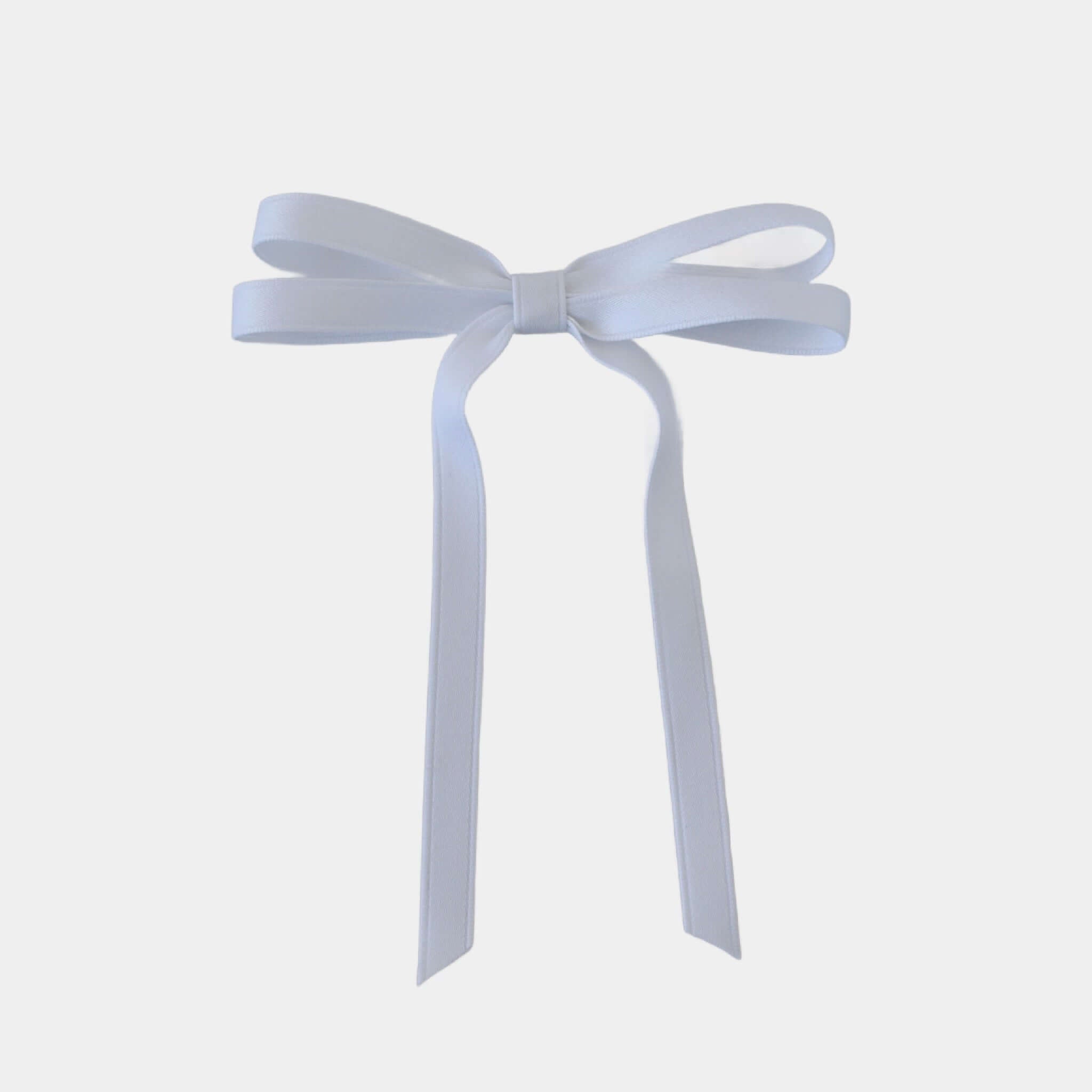 Olivia petite matte satin hair bow in white on a white background.