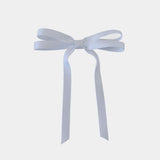 Olivia petite matte satin hair bow in white on a white background.