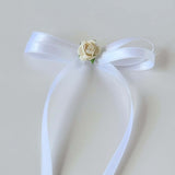 White satin Olivia bow with ivory rose flower accent-close-up on flower