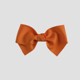 Orange bow on a white background