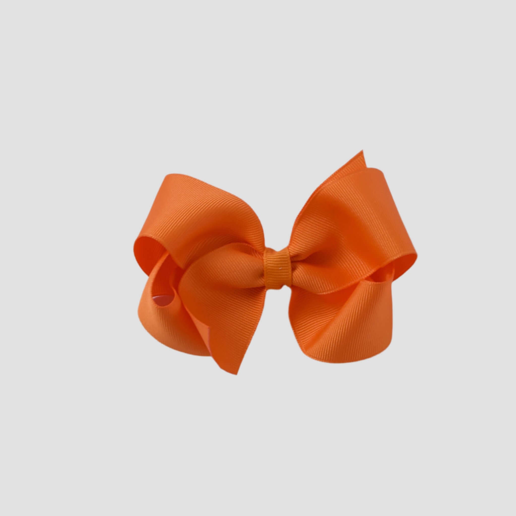 Orange hair bow on a white background