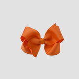 Orange hair bow on a white background
