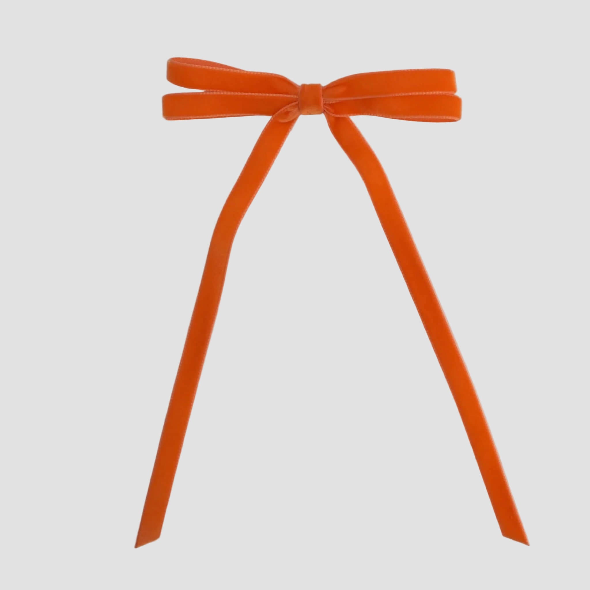 Orange Olivia velvet hair bow for women with long tails on white background