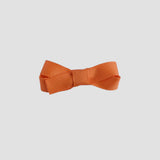 Orange bow on a white background