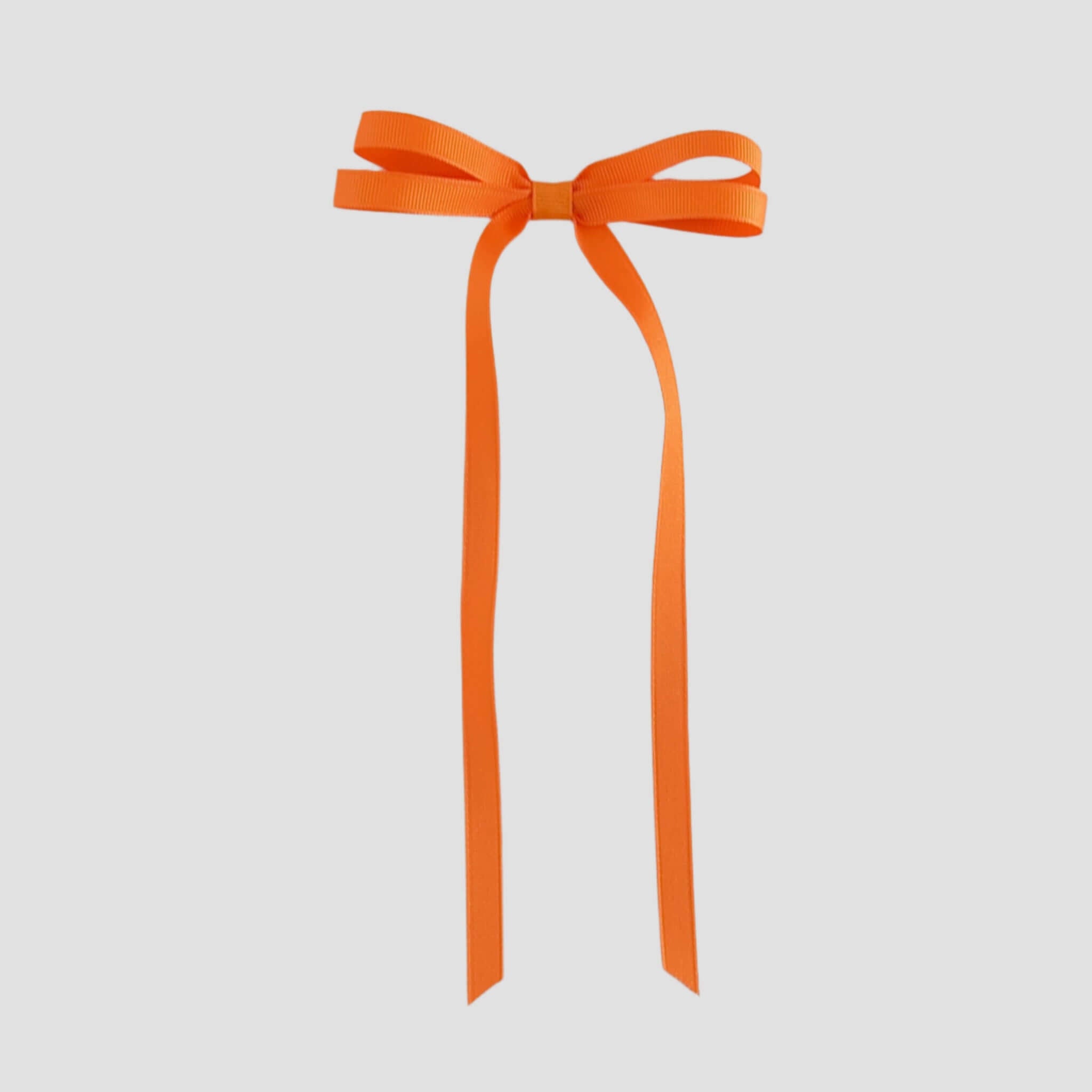 Orange ribbon bow on a white background