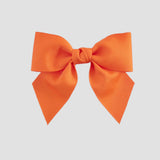 Orange bow on a white background