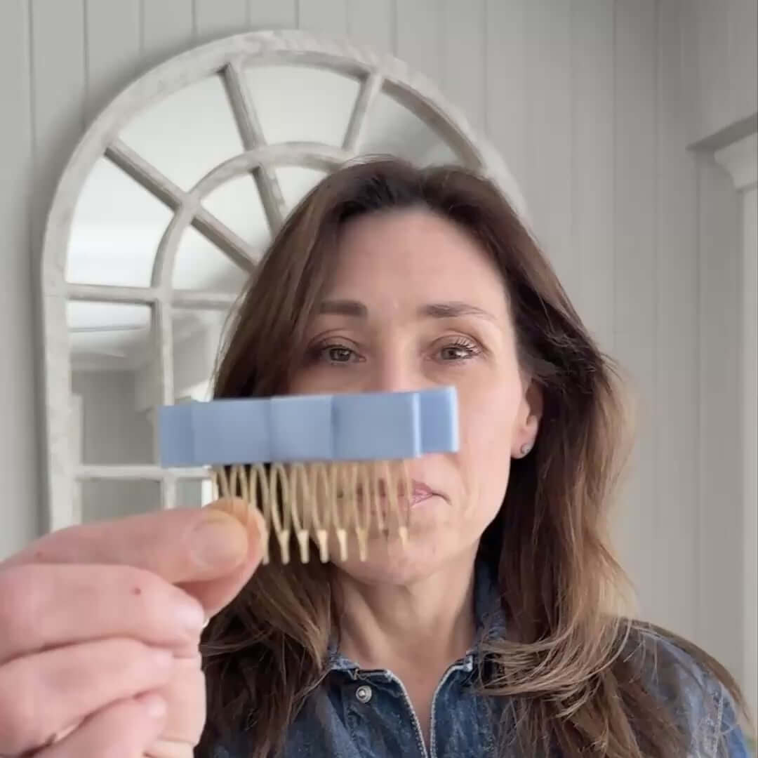 Video of woman styling hair with a satin bow comb clip