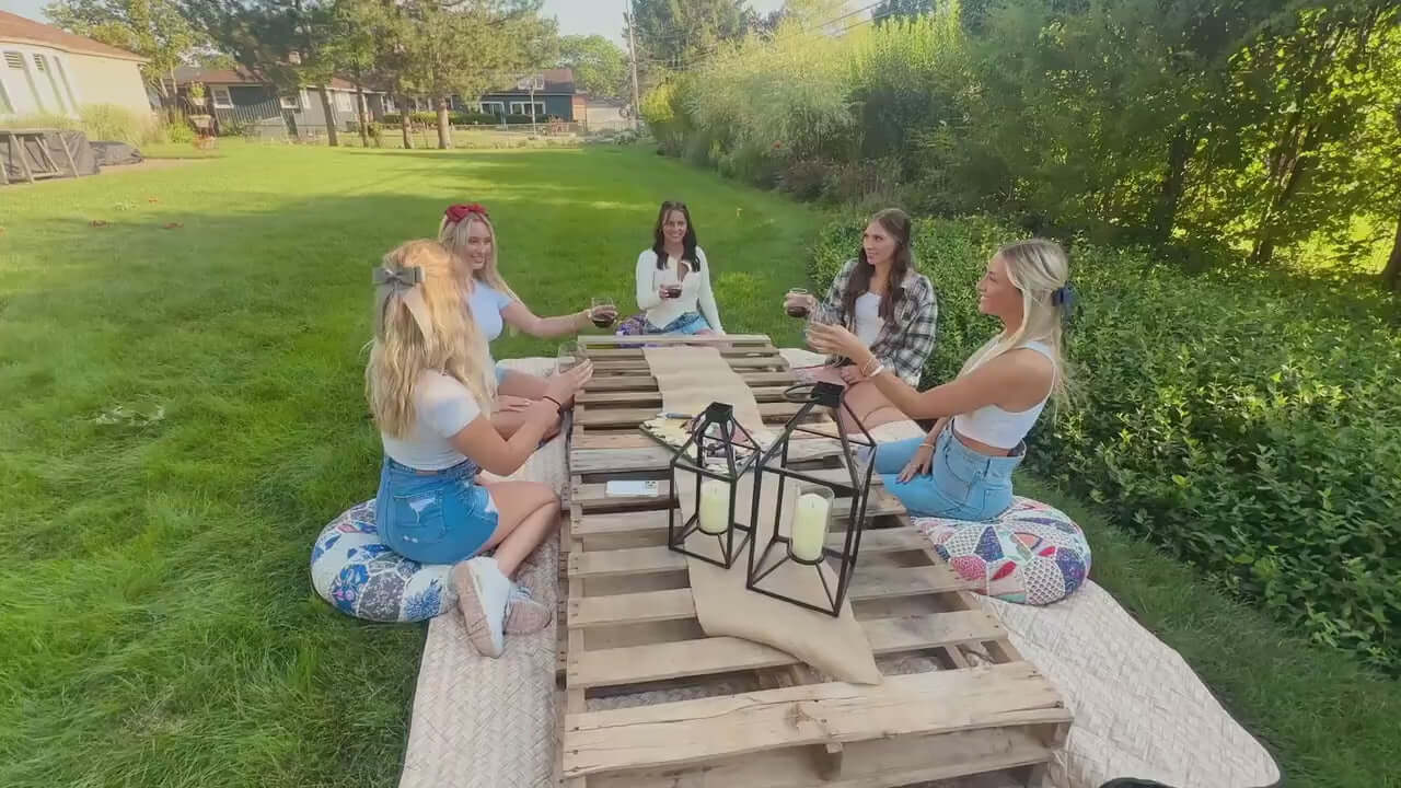 Young women having a picnic while wearing grosgrain ribbon hair bows.   