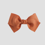 Pumpkin orange bow on a white background