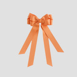 Pumpkin orange bow on a white background