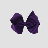 Purple hair bow on a white background