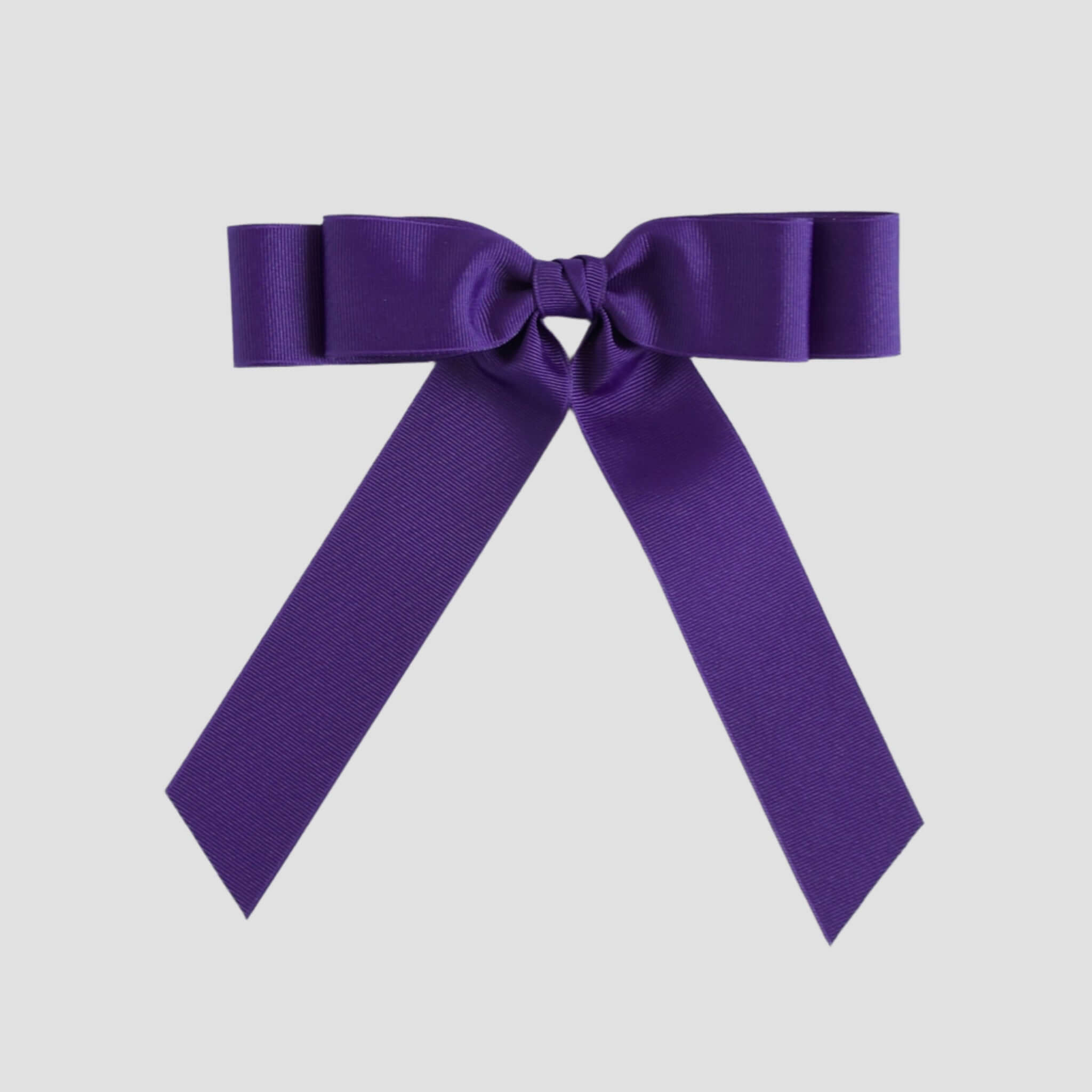 Purple bow on a white background