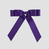 Purple bow on a white background