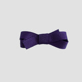 Purple bow on a white background
