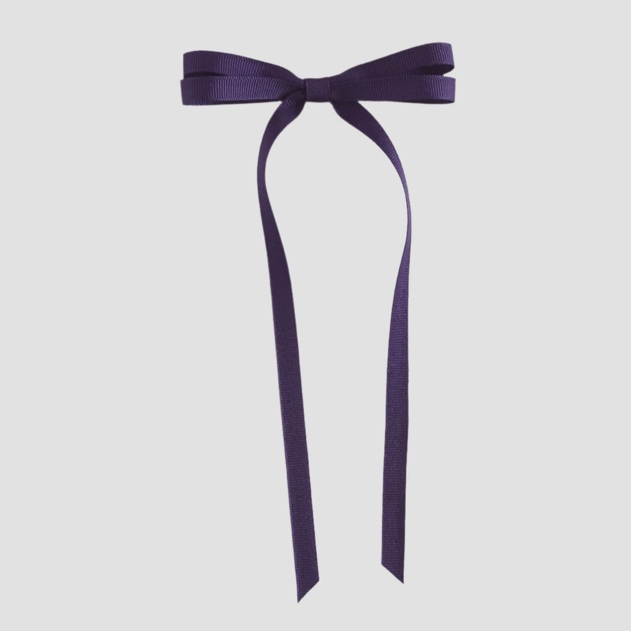 Purple ribbon bow on a white background