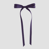 Purple ribbon bow on a white background