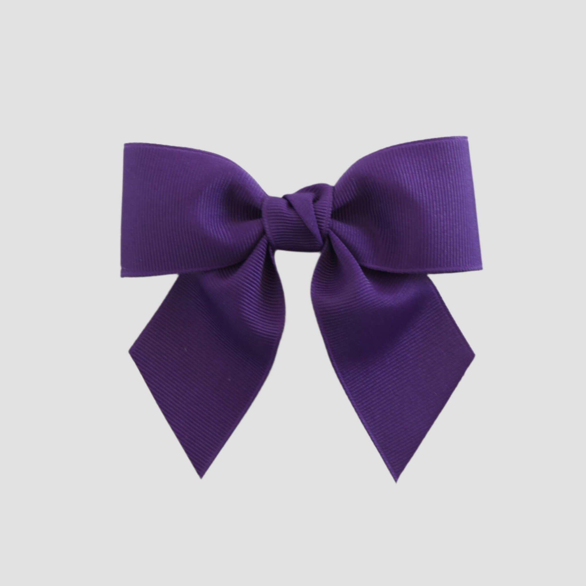 Purple bow on a white background