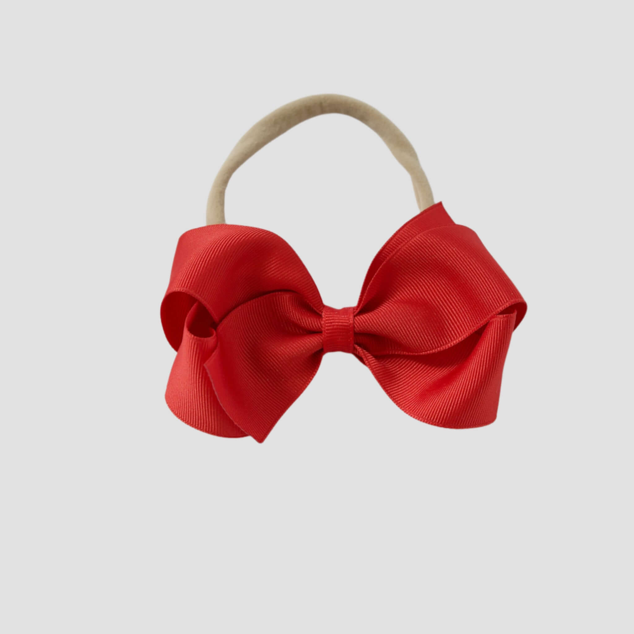 Red bow on a nude nylon headband