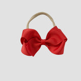 Red bow on a nude nylon headband