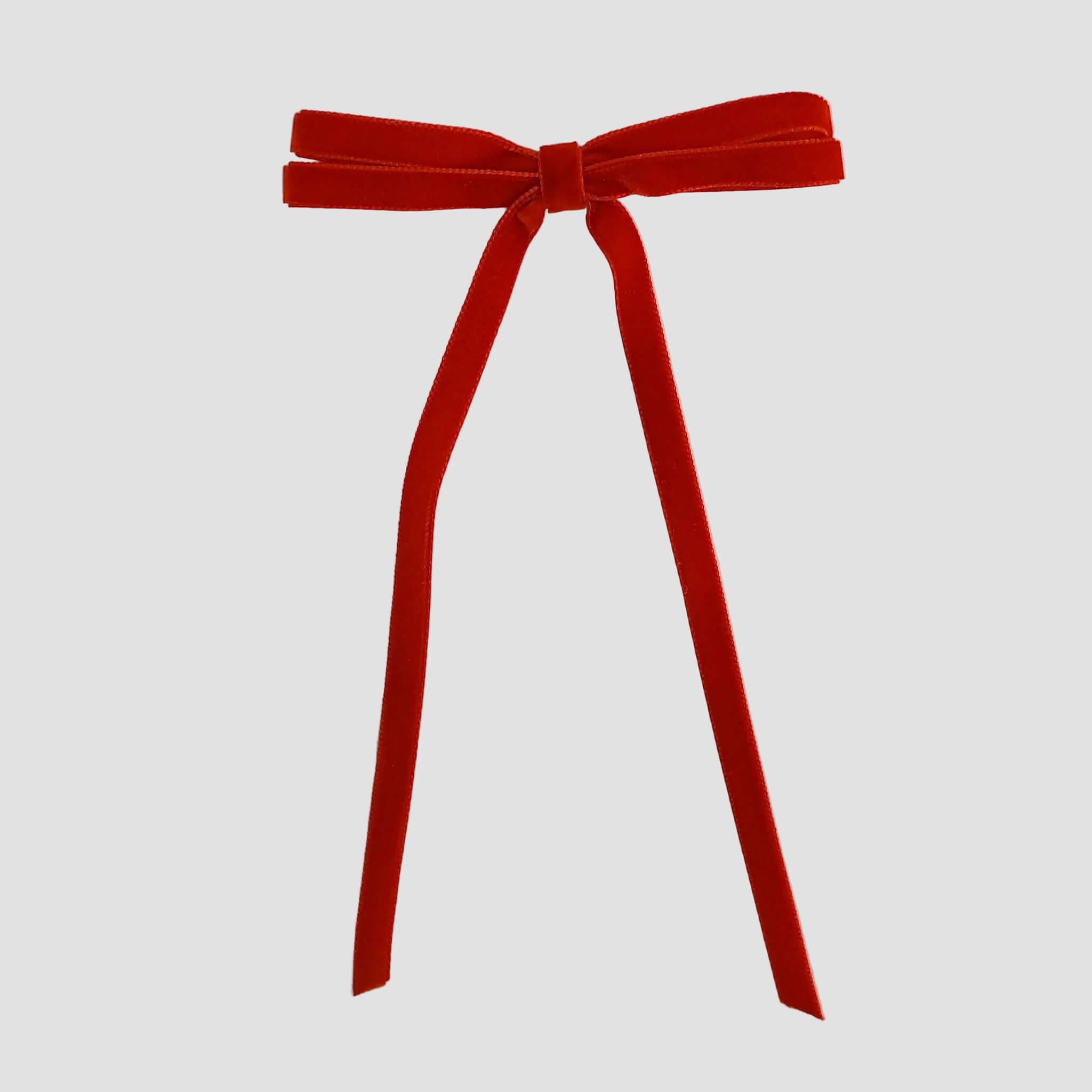 Red Olivia velvet hair bow for women with long tails on white background