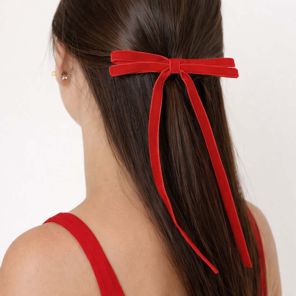 Red Olivia velvet hair bow for women with long tails styled in half-up hairstyle