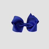 Royal blue hair bow on a white background