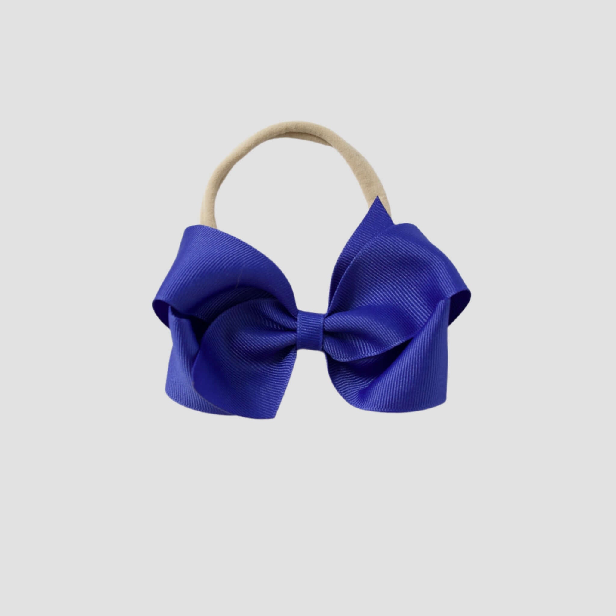 Royal blue bow on a nude nylon headband
