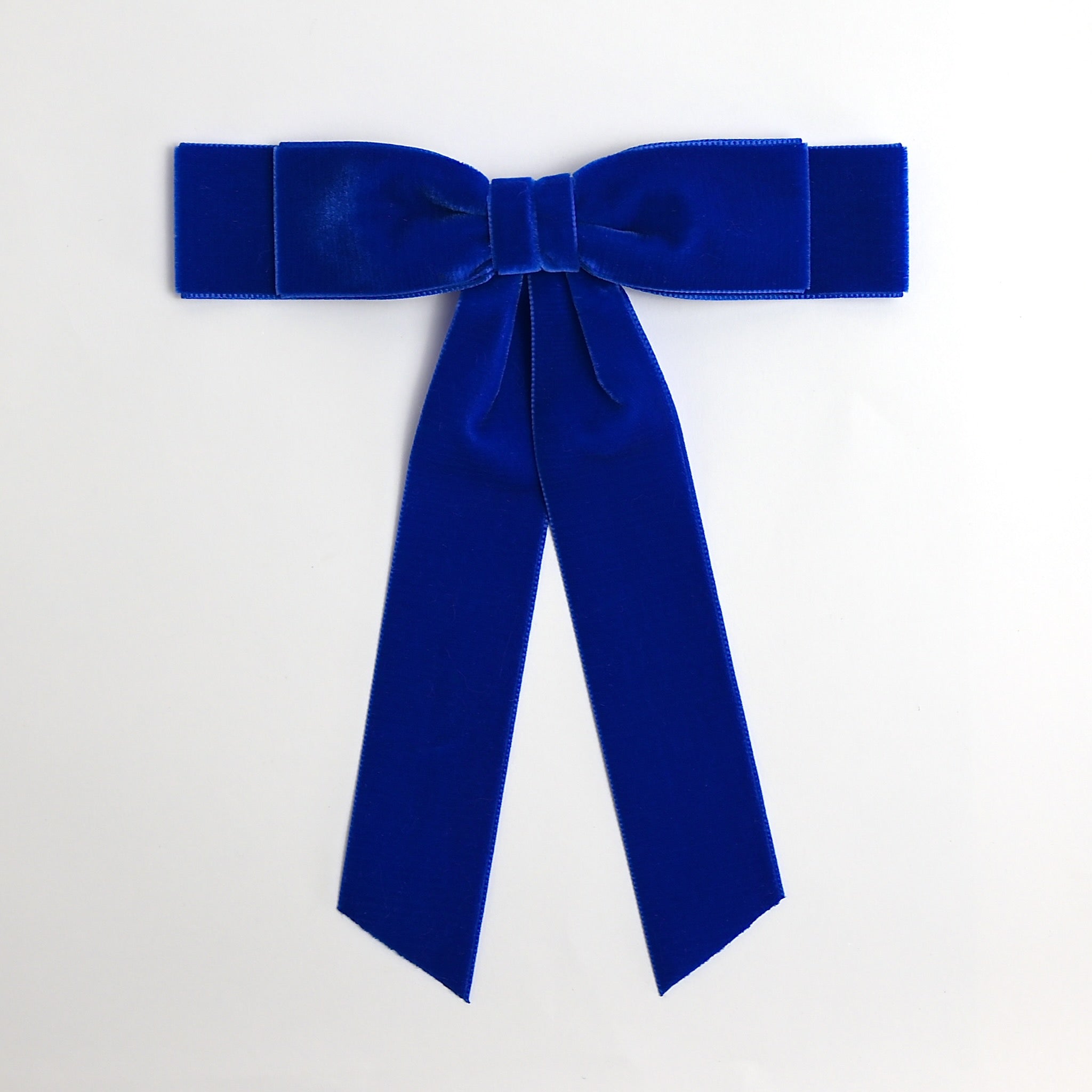 Royal blue Grace velvet hair bow for women. Double bow with long tails on white background 