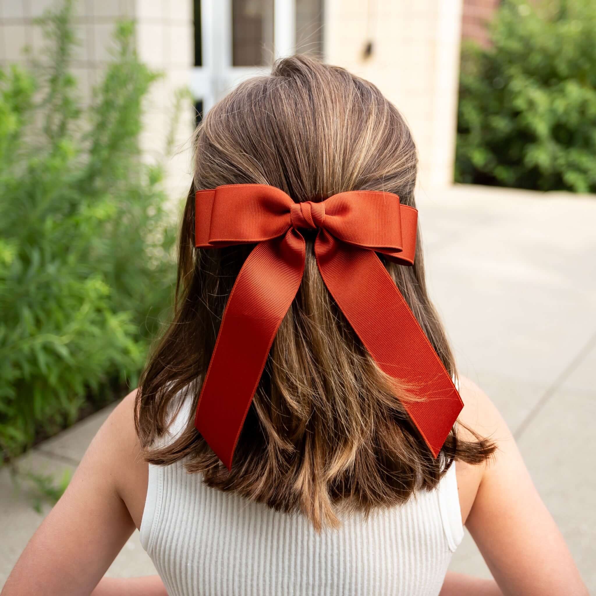 Young girl with Grace grosgrain hair bow in her hair.